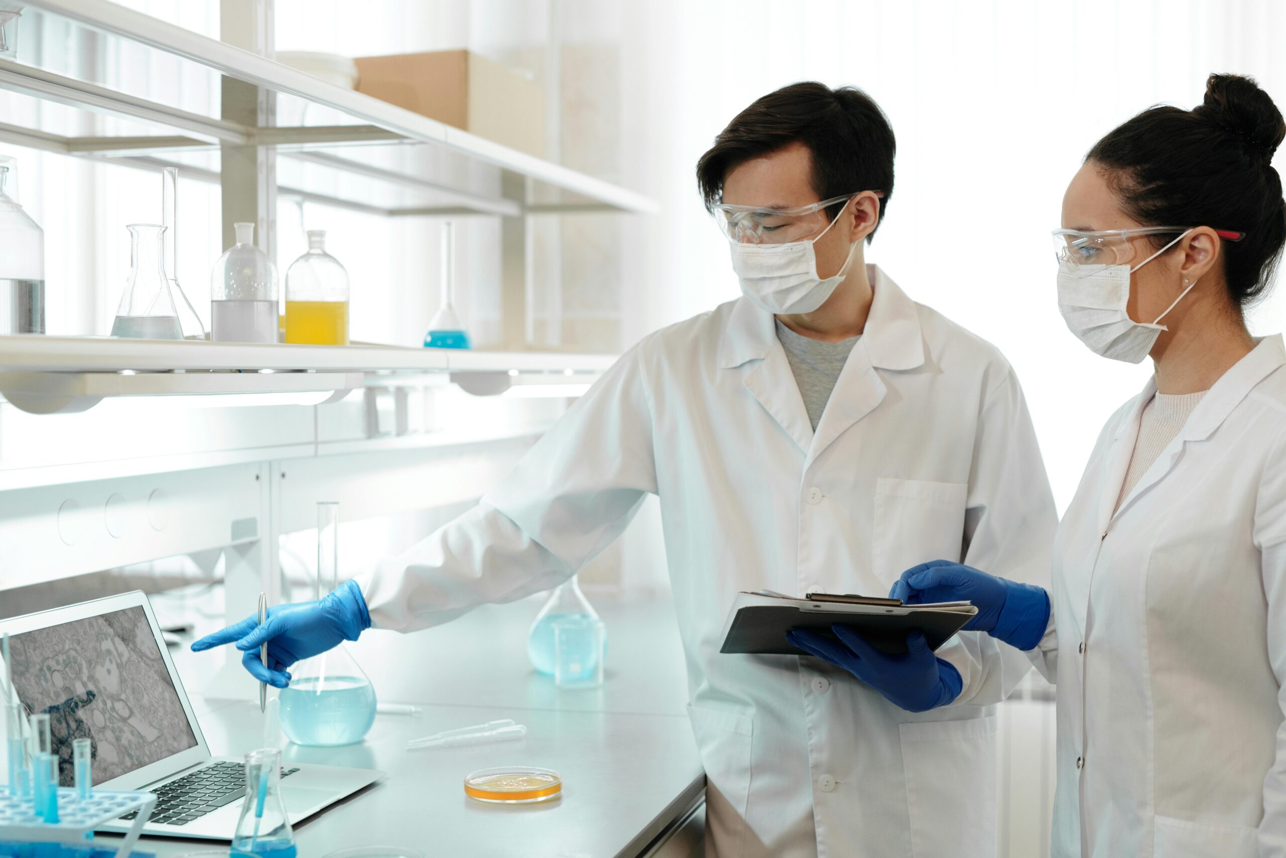 Scientists Analyzing Lab Data in Clean Biotech Laboratory
